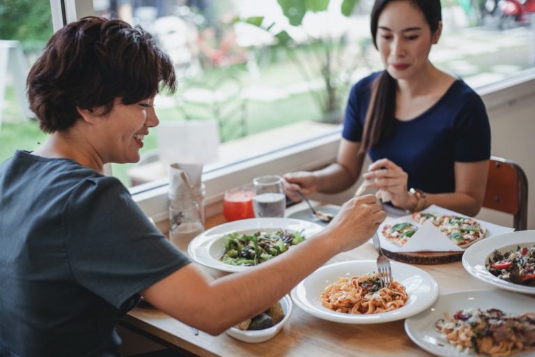 Asian women hungry on keto having lunch in restaurant