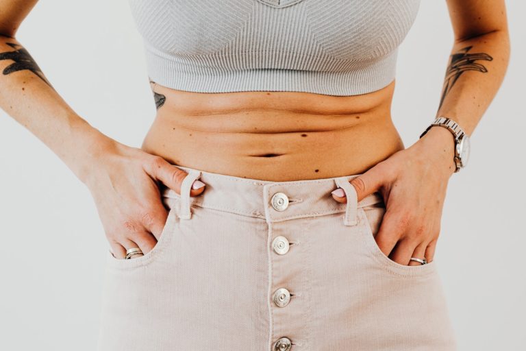 Is Keto Bad For Your Stomach? Close-up of a Stomach of a Woman in a Sports Bra
