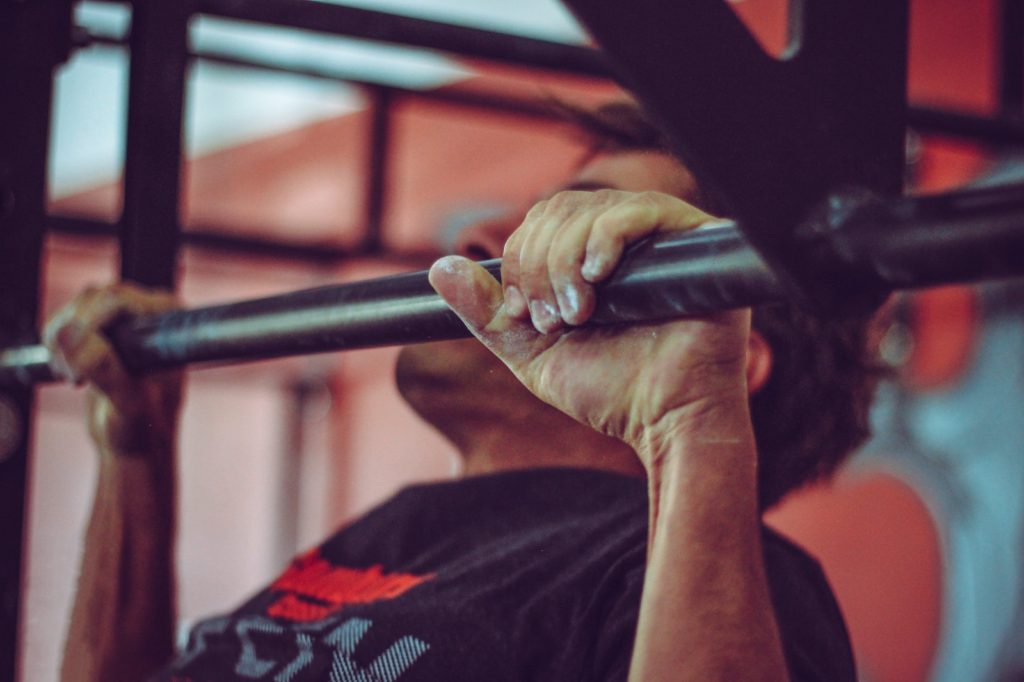 Man In Black Crew-neck Shirt Doing Pull-ups In a Full-Body Split or Bro Split