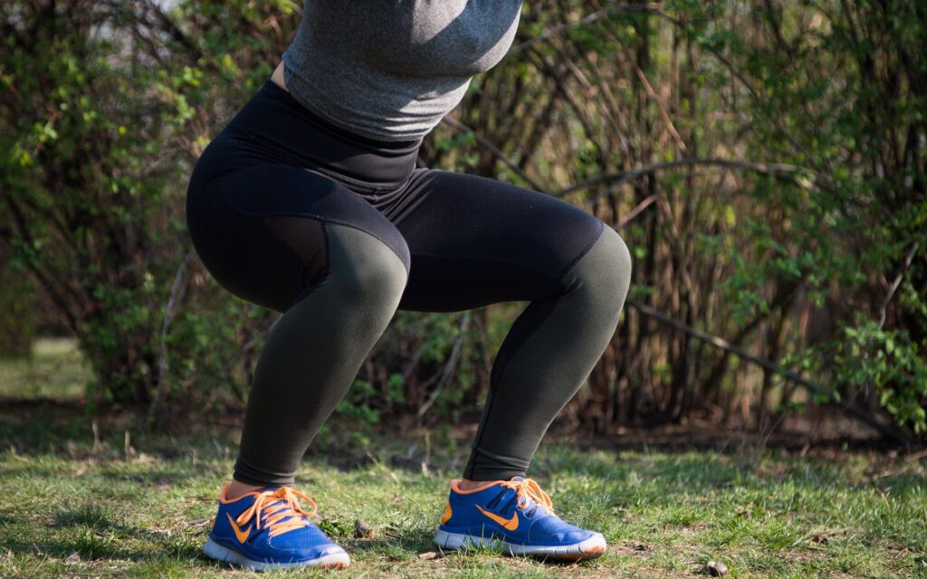 Woman squatting outside